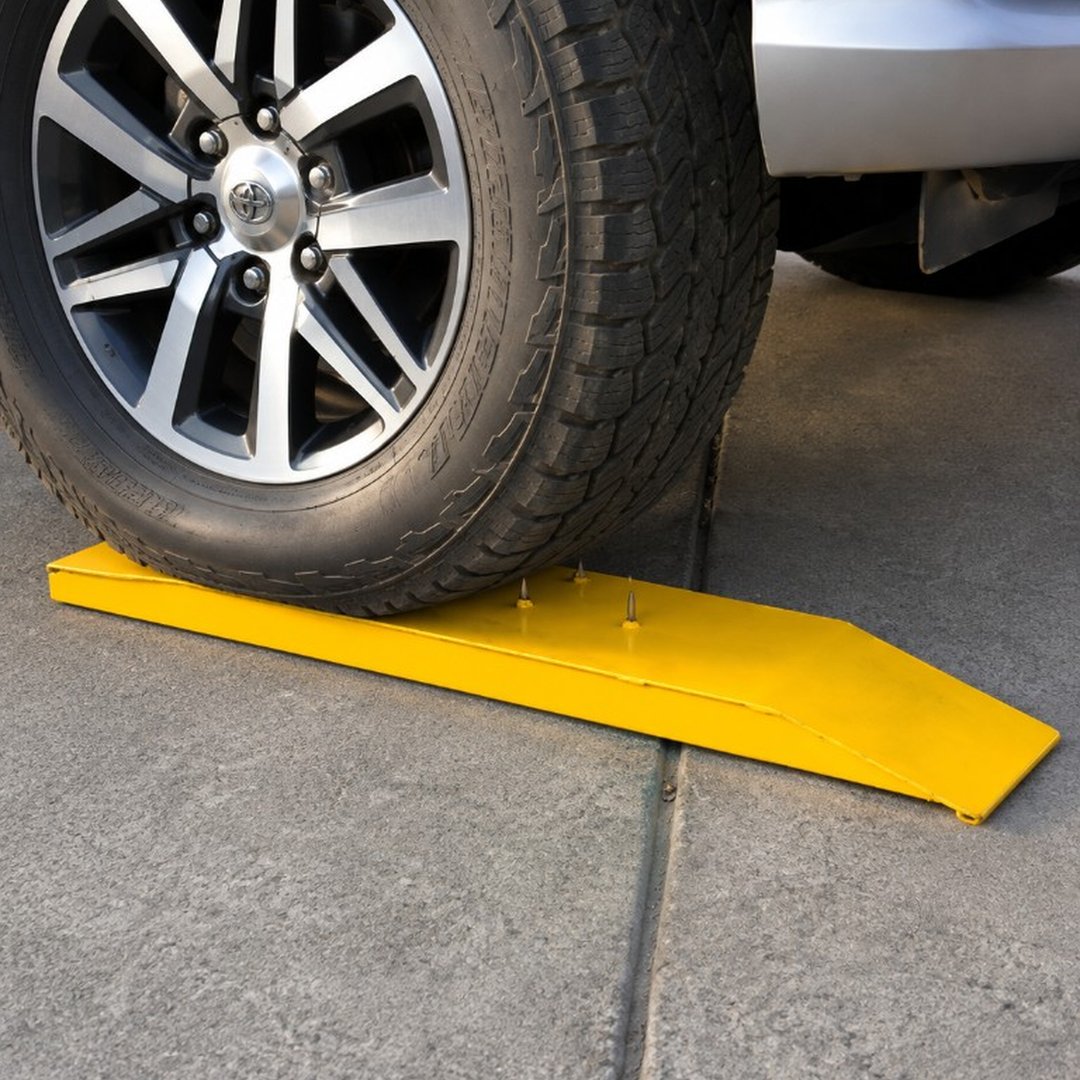 Vehicle tyre rolling over a spike strip on the road